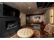 This basement features wood look tile, a leather couch, and a fireplace with a large TV at 4313 Kingswood Rd, Charlotte, NC 28226