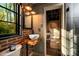 Unique bathroom featuring a vessel sink on a live-edge wood countertop, and exposed brick at 4313 Kingswood Rd, Charlotte, NC 28226