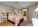 Comfortable bedroom with hardwood floors, a decorative bedspread, and natural light at 4313 Kingswood Rd, Charlotte, NC 28226