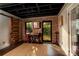 Inviting bonus room with exposed brick walls, hardwood floors, and a charming vintage popcorn machine at 4313 Kingswood Rd, Charlotte, NC 28226