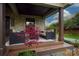 Cozy front porch with stone accents, outdoor seating, and a manicured lawn at 4313 Kingswood Rd, Charlotte, NC 28226