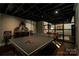 Spacious game room featuring a sleek ping pong table and stylish decor elements in a finished basement at 4313 Kingswood Rd, Charlotte, NC 28226