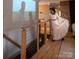 Hallway with hardwood floors, featuring wood handrails and a large projector screen at 4313 Kingswood Rd, Charlotte, NC 28226