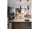Bright kitchen showcasing a brick accent wall, white cabinetry, stainless steel appliances, and hardwood flooring at 4313 Kingswood Rd, Charlotte, NC 28226