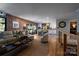 Open concept living area flows into the kitchen with brick accent walls and hardwood floors at 4313 Kingswood Rd, Charlotte, NC 28226