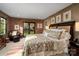 Serene primary bedroom with exposed brick accents and a cozy sitting area, providing an inviting retreat at 4313 Kingswood Rd, Charlotte, NC 28226