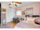 A pink bedroom with hardwood floors, a ceiling fan, a comfortable chair, and a closet providing ample storage at 536 Shiloh Church Rd, Hickory, NC 28601