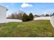 Large backyard featuring a grassy yard and a tall white fence at 6019 Timbertop Ln, Charlotte, NC 28215