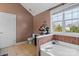 Bathroom featuring a soaking tub, and a toilet with a window to the right at 6019 Timbertop Ln, Charlotte, NC 28215