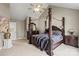 Elegant main bedroom with a four-poster bed and natural light from the windows at 6019 Timbertop Ln, Charlotte, NC 28215