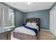 Bedroom featuring a bed, a window and light gray curtains at 6019 Timbertop Ln, Charlotte, NC 28215