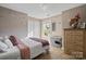 Bedroom featuring a bed, a butterfly designed wall, and a window at 6019 Timbertop Ln, Charlotte, NC 28215