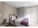 Bedroom featuring a bed, a decorated wall and a small side table at 6019 Timbertop Ln, Charlotte, NC 28215