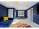 Bonus room featuring blue walls, a comfortable couch and a center desk at 6019 Timbertop Ln, Charlotte, NC 28215