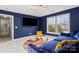 Bonus room featuring blue walls, plush seating, and a flat screen tv at 6019 Timbertop Ln, Charlotte, NC 28215