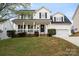 Charming two-story home with a welcoming front porch and well-maintained landscaping at 6019 Timbertop Ln, Charlotte, NC 28215