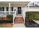 Inviting front porch with brick steps and manicured shrubs enhancing curb appeal at 6019 Timbertop Ln, Charlotte, NC 28215