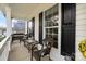 Cozy front porch seating area with wicker furniture and natural light at 6019 Timbertop Ln, Charlotte, NC 28215