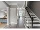 Hallway showcasing hardwood floors, an adjacent staircase, and access to the living areas at 6019 Timbertop Ln, Charlotte, NC 28215