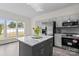 Modern kitchen features gray cabinets, stainless steel appliances, and a marble-topped island at 6019 Timbertop Ln, Charlotte, NC 28215