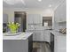 Well-lit kitchen with gray cabinets, marble countertops, and modern appliances offers a functional design at 6019 Timbertop Ln, Charlotte, NC 28215