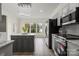 Modern kitchen featuring gray cabinets, stainless steel appliances, and an island at 6019 Timbertop Ln, Charlotte, NC 28215