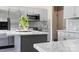 Kitchen view with stainless steel appliances, a marble countertop island, and gray cabinetry at 6019 Timbertop Ln, Charlotte, NC 28215