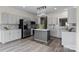 Spacious kitchen featuring gray cabinets, stainless steel appliances, and a central island for prep at 6019 Timbertop Ln, Charlotte, NC 28215