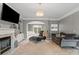 Inviting living room featuring a fireplace, built-in shelves, plush seating, and elegant lighting at 6019 Timbertop Ln, Charlotte, NC 28215