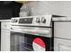 Close up of a new stainless steel Frigidaire oven with gray cabinets around it at 6019 Timbertop Ln, Charlotte, NC 28215