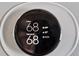 Close-up of a smart thermostat displaying indoor temperature and settings at 6019 Timbertop Ln, Charlotte, NC 28215