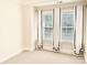 Well lit bedroom showcasing two windows and neutral colored carpet at 735 Amalfi Dr, Davidson, NC 28036