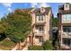 Charming townhome with brick facade, red door, and balconies under a sunny blue sky at 735 Amalfi Dr, Davidson, NC 28036