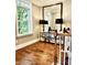 Hallway with hardwood floors, decorative mirror, and staircase at 735 Amalfi Dr, Davidson, NC 28036