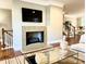 Living room with a stone fireplace, adjacent staircase, and neutral decor at 735 Amalfi Dr, Davidson, NC 28036