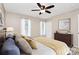 Comfortable bedroom features a ceiling fan, two windows, and a dark wood dresser at 11 Tanglewood Rd, Lake Wylie, SC 29710