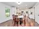 Open kitchen and dining area with white cabinetry, stainless appliances, and hardwood flooring at 11 Tanglewood Rd, Lake Wylie, SC 29710