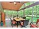 Relaxing screened porch with outdoor seating and views of the surrounding woods at 11 Tanglewood Rd, Lake Wylie, SC 29710