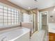 Bathroom featuring glass shower, soaking tub, tile flooring, and walk-in closet at 111 Forest Walk Way, Mooresville, NC 28115