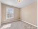 Bright bedroom with carpet, natural light from a single window, and neutral walls at 111 Forest Walk Way, Mooresville, NC 28115