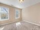 Bedroom with carpeted floor, light walls, and double windows at 111 Forest Walk Way, Mooresville, NC 28115