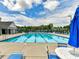 Enjoy a refreshing swim in the community pool, surrounded by comfortable seating and lush greenery at 111 Forest Walk Way, Mooresville, NC 28115