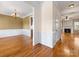 Open dining room with hardwood floors, chandelier, and decorative molding at 111 Forest Walk Way, Mooresville, NC 28115