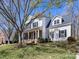 Well-maintained two-story home with a welcoming front porch and landscaped yard at 111 Forest Walk Way, Mooresville, NC 28115