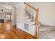 Foyer featuring hardwood floors, a staircase, and views into the living room at 111 Forest Walk Way, Mooresville, NC 28115