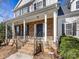 Inviting front porch with stone accents, black door, and classic columns at 111 Forest Walk Way, Mooresville, NC 28115