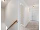 Hallway features neutral walls, carpeted floors, and a staircase with wooden railing, connecting the home's levels at 111 Forest Walk Way, Mooresville, NC 28115