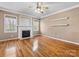 Bright living room featuring a fireplace, hardwood floors, and neutral paint, perfect for relaxing and entertaining at 111 Forest Walk Way, Mooresville, NC 28115