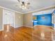 Open-concept living room featuring hardwood floors, neutral paint, and seamless flow into the dining and entry areas at 111 Forest Walk Way, Mooresville, NC 28115