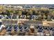 An aerial view shows townhomes and houses in a well-maintained community with tree-lined streets in the background at 12124 Red Rust Ln, Charlotte, NC 28277